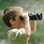 boy looking through binoculars